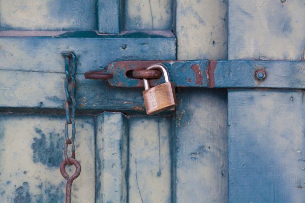 gold-padlock-locking-door-164425
