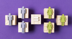wooden-cubes-with-green-women-blue-men-figurines-equality-concept-top-view