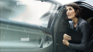 Businesswoman getting out from a car