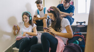 group-schoolkids-looking-smartphones