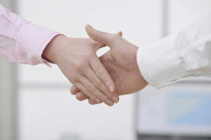 Man and woman shaking hands, close up