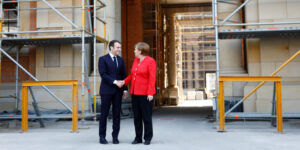 German Chancellor Angela Merkel welcomes French President Emmanuel Macron at the building site of the Humboldt Forum in Berlin, Germany, April 19, 2018. REUTERS/Axel Schmidt