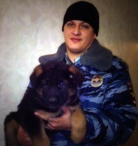 == RESTRICTED TO EDITORIAL USE - MANDATORY CREDIT "AFP PHOTO / RUSSIA'S INTERIOR MINISTRY" - NO MARKETING NO ADVERTISING CAMPAIGNS - DISTRIBUTED AS A SERVICE TO CLIENT == This handout picture released on November 21, 2015 by Russia's Interior ministry shows a Russian officer holding a puppy named Dobrynya in Moscow. Russia has offered to send an Alsatian puppy to France in a gesture of solidarity after police dog named Diesel was killed during a raid on jihadists linked to the Paris attacks in Saint-Denis, suburban Paris, on November 18, 2015.  AFP PHOTO / RUSSIA'S INTERIOR MINISTRY