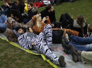 Activists dressed like animals stage a die in during a demonstration near the Eiffel Tower, in Paris, Saturday, Dec.12, 2015 during the COP21, the United Nations Climate Change Conference. As organizers of the Paris climate talks presented what they hope is a final draft of the accord, protesters from environmental and human rights groups gather to call attention to populations threatened by rising seas and increasing droughts and floods. (AP Photo/Matt Dunham)