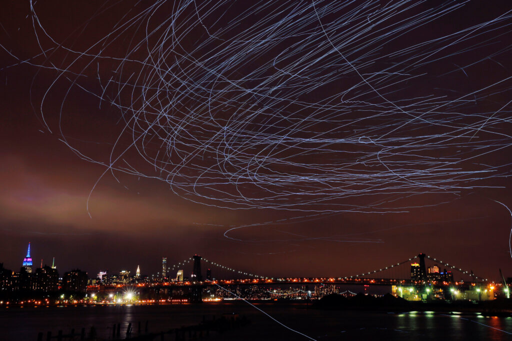 LED lights attached to pigeons leave light trails in the sky while they fly as part of the "Fly By Night" art installation by Duke Riley above the Brooklyn borough of New York, U.S.,May 5, 2016. REUTERS/Lucas Jackson TPX IMAGES OF THE DAY