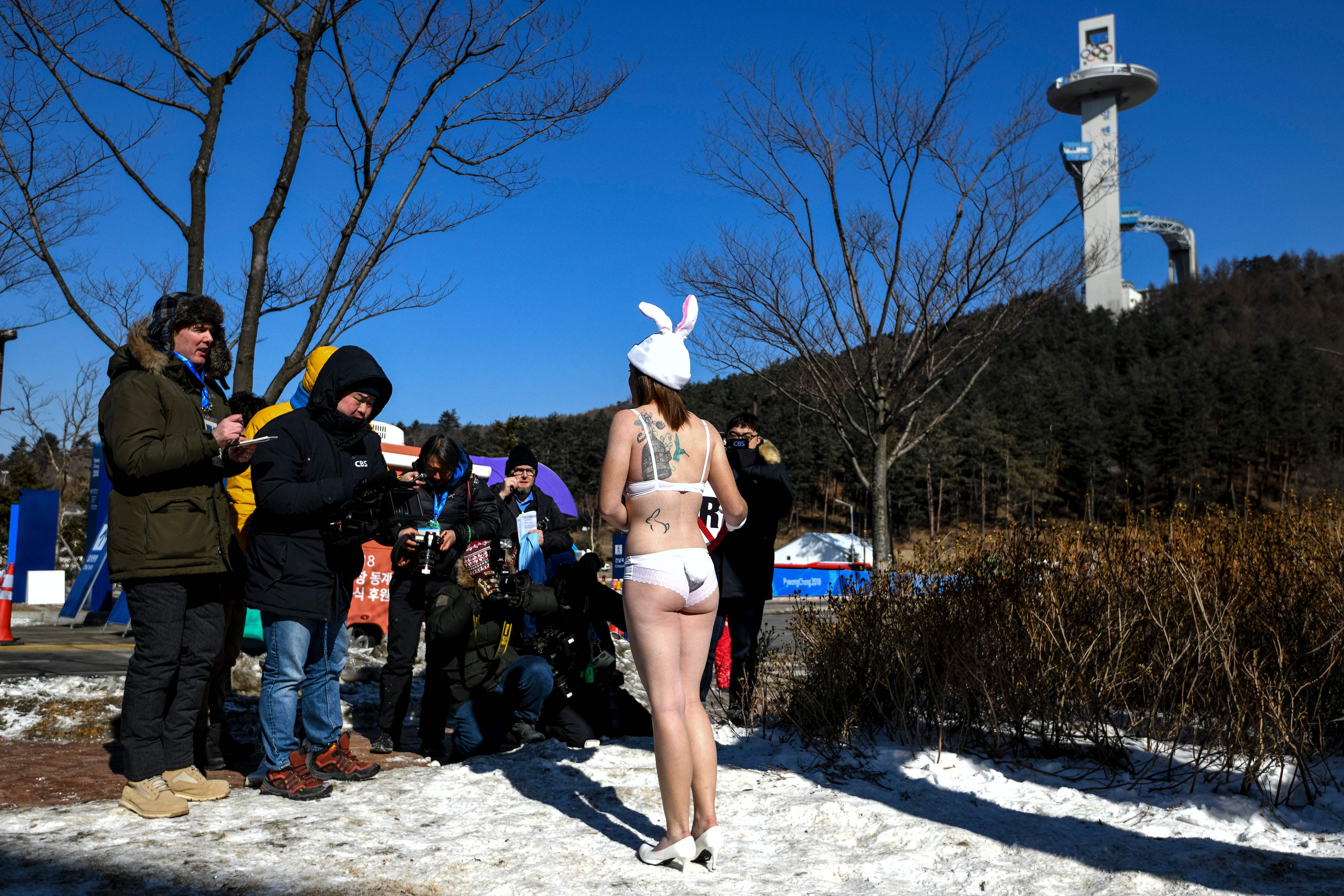 An activist of the People for the Ethical Treatment of Animals (PETA) attends a protest next the Olympics ski jumping tower ahead of the Pyeongchang 2018 Winter Olympic Games in Pyeongchang on February 6, 2018. / AFP PHOTO / Dimitar DILKOFF