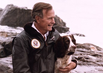 P24216-05A President Bush with his Springer Spaniel, Ranger, on the rocks outside their home on Walker's Point, Kennebunkport, ME, 10 Aug 91. Photo Credit: George Bush Presidential Library and Museum