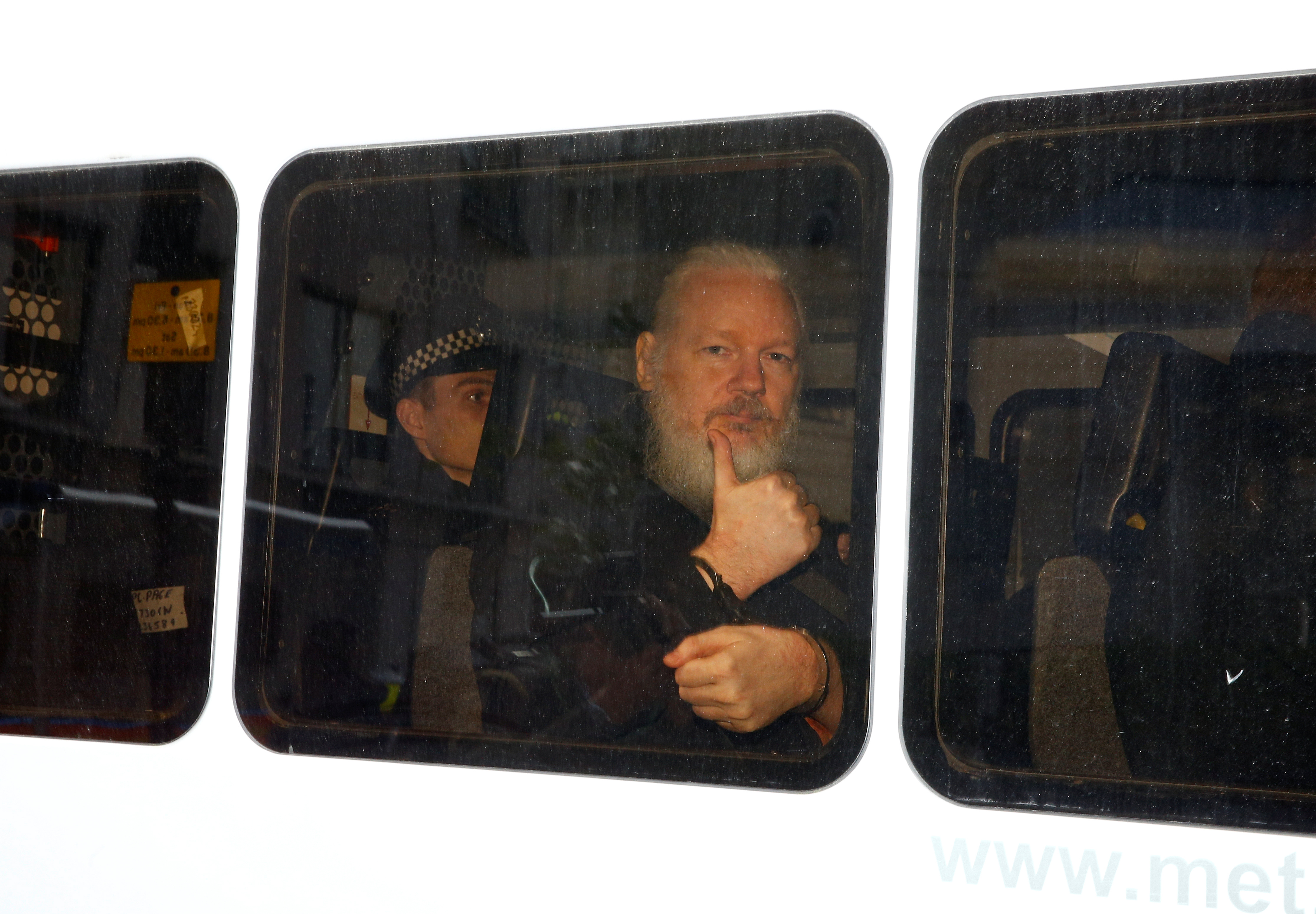 WikiLeaks founder Julian Assange is seen in a police van after was arrested by British police outside the Ecuadorian embassy in London, Britain April 11, 2019. REUTERS/Henry Nicholls TPX IMAGES OF THE DAY
