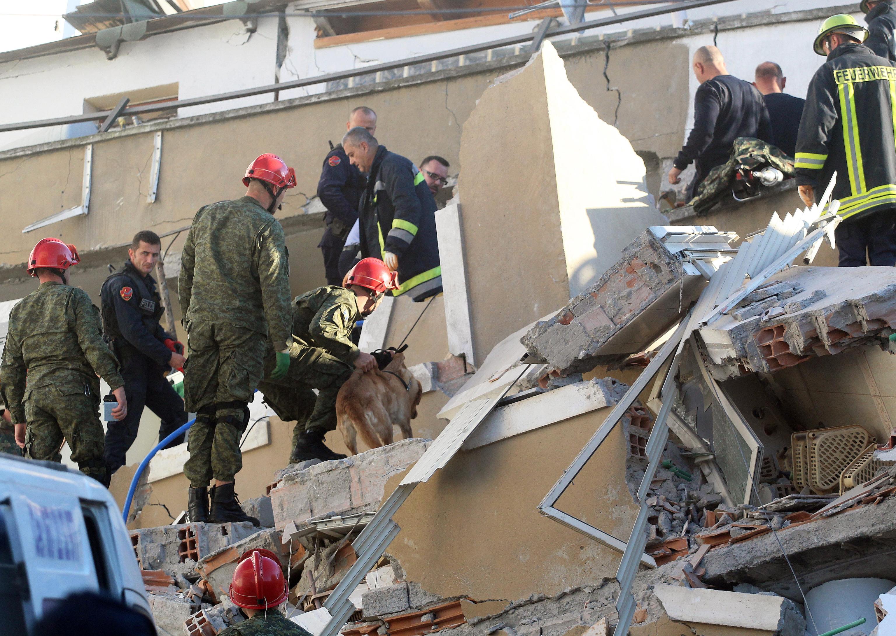 epa08027342 Rescue teams of firemen, army and police search for survivors in the rubble of a collapsed building after an earthquake in Durres, Albania, 26 November 2019. Albania was hit by a 6.4 magnitude earthquake on 26 November 2019, the strongest recorded in decades. According to reports, at least 18 people have died and several are injured in the eartquke EPA/MALTON DIBRA