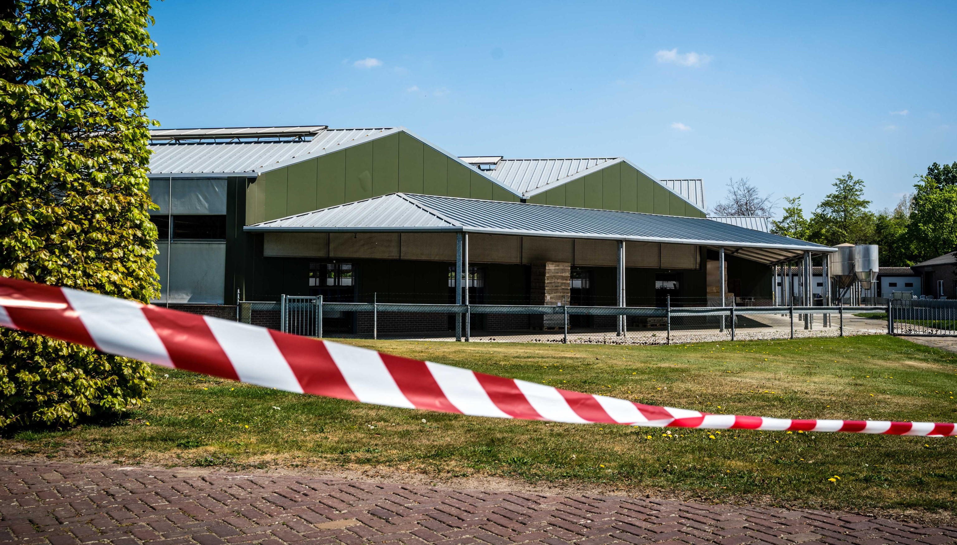 epa08385089 General view of a closed off mink farm in Beek en Donk, the Netherlands, 26 April 2020. Covid-19 has been confirmed in mink at two fur farms in the Netherlands, the agriculture ministry confirmed. The animals were tested after developing a variety of symptoms. Public health institute RIVM has sealed off an area some 400 metres around each farm  EPA/ROB ENGELAAR
