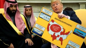 U.S. President Donald Trump holds a chart of military hardware sales as he welcomes Saudi Arabia's Crown Prince Mohammed bin Salman in the Oval Office at the White House in Washington, U.S. March 20, 2018.  REUTERS/Jonathan Ernst - RC14FF352EF0